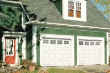 A picture of 2 single garage doors in Classic CC design, 9' x 7', Ice White color, 4 lite Orion windows